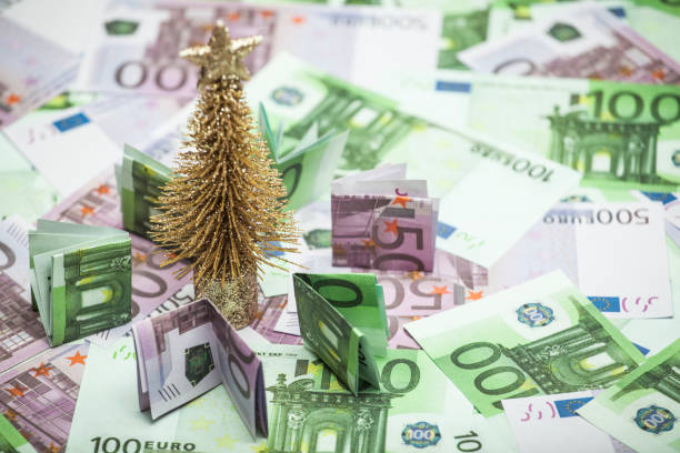 istock miniature gold fir tree money table background 1181037150