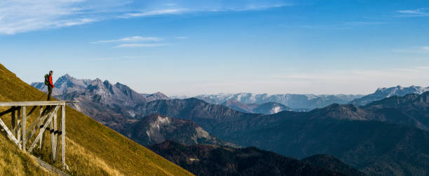 istock Young active man with backpack and trekking poles 1181037775