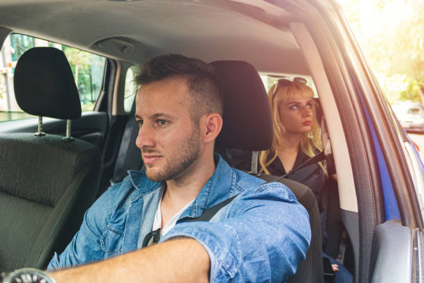 istock Driver inside a car with a young woman as a passenger. 1181038220