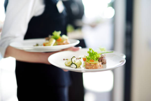 istock Waiter carrying plates with meat dish 1181039094