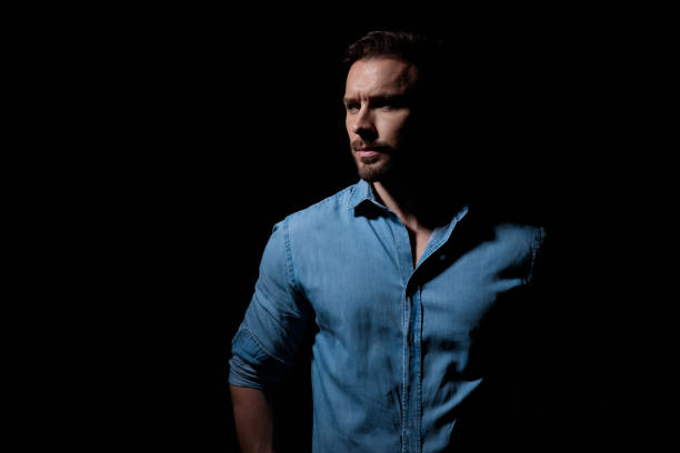 istock casual man standing and looking aside pensive 1181041002