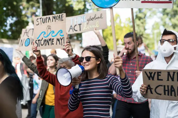 Photo of People with placards and amplifier on global strike for climate change.