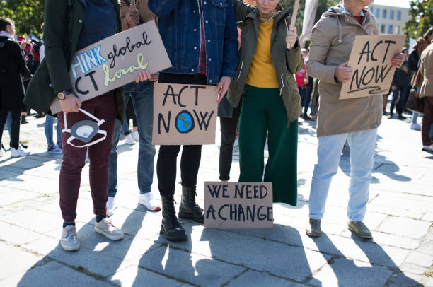 istock People with placards and posters on global strike for climate change, midsection. 1181042206