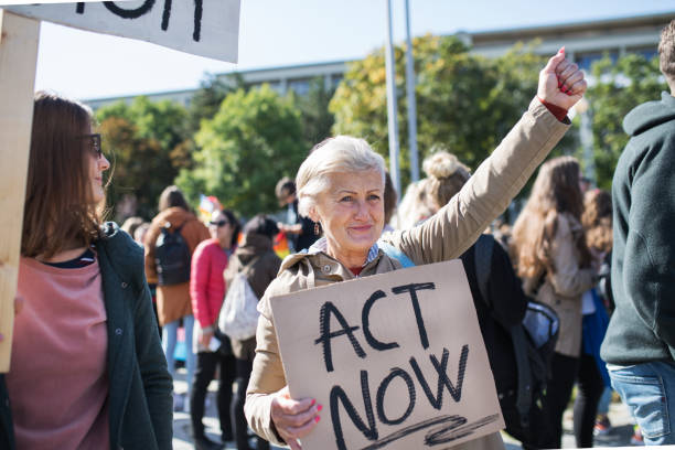 istock Senior with placard and poster on global strike for climate change. 1181043861