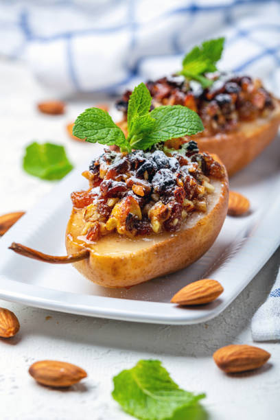 istock Pears baked with raisins, nuts, honey and mint. 1181043949
