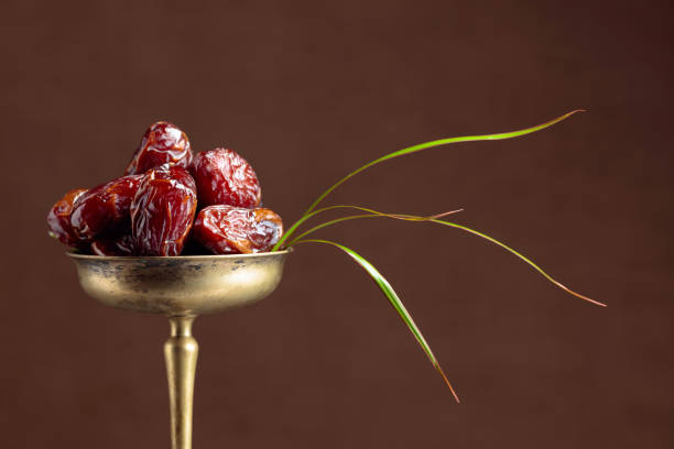 istock Closeup sweet dried dates in brass dish. 1181046651