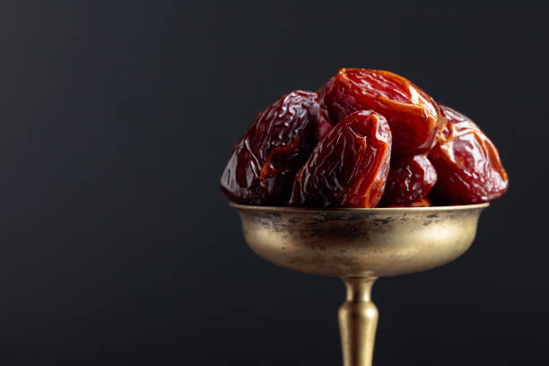 istock Closeup sweet dried dates in brass dish. 1181046761