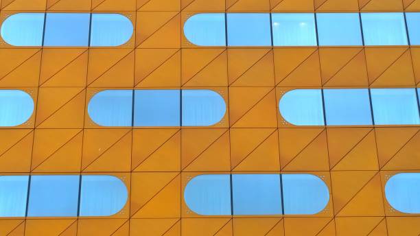 istock Orange Facade of building with oval shaped mirror windows. Modern architecture background. Geometry of skyscraper. Design and construction industry concept. Urban real estate. 1181049669