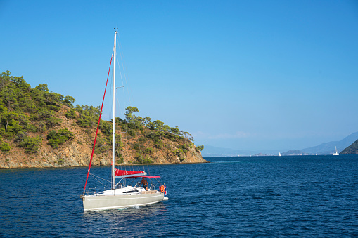 Gocek, Fethiye,Mugla/Turkey-October 06,2019:  man is sailing at the turquoise sea of Gocek Bay, Fethiye, Turkey