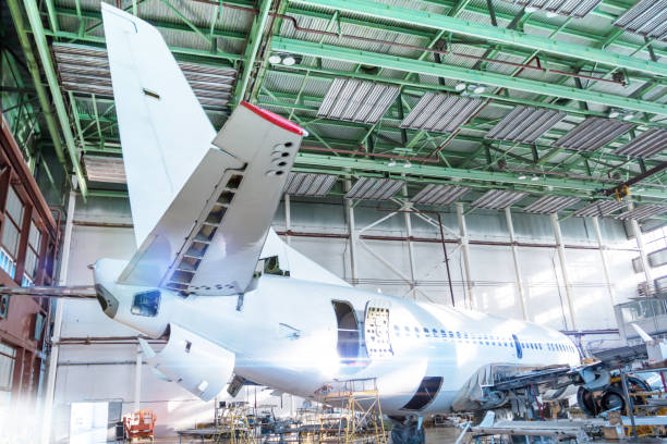 istock Passenger jet plane under maintenance in the hangar. Checking mechanical systems for flight operations. Close-up view of the tail of the airplane 1181053432