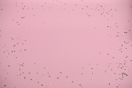 Sparkles on a pink background. Background for congratulations or Christmas background.