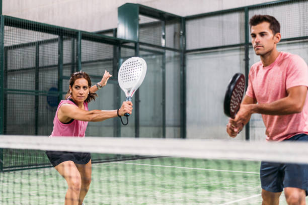 mixed padel match in a padel court indoor stock photo