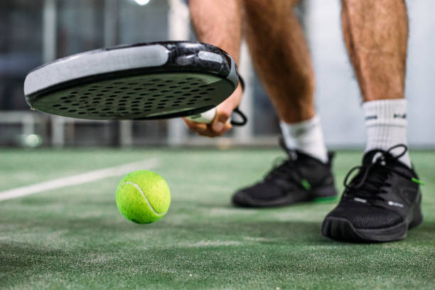istock Crop man taking padel ball from ground 1181056019