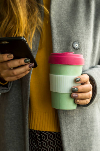 istock Modern coffee cup in the concept of zero waste in a woman's hands 1181056666