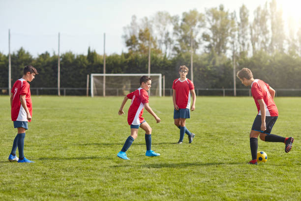 istock Young Male Footballers in Spain Practicing Passing Drills 1181056818