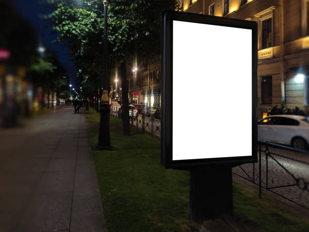 istock vertical small city advertising billboard city format. mockup at night with white field billboard in the city in the alley 1181056849