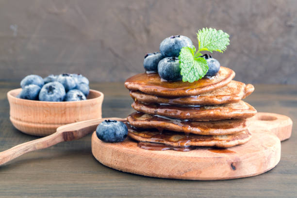 istock Chocolate pancakes with blueberries on a dark background. 1181058137