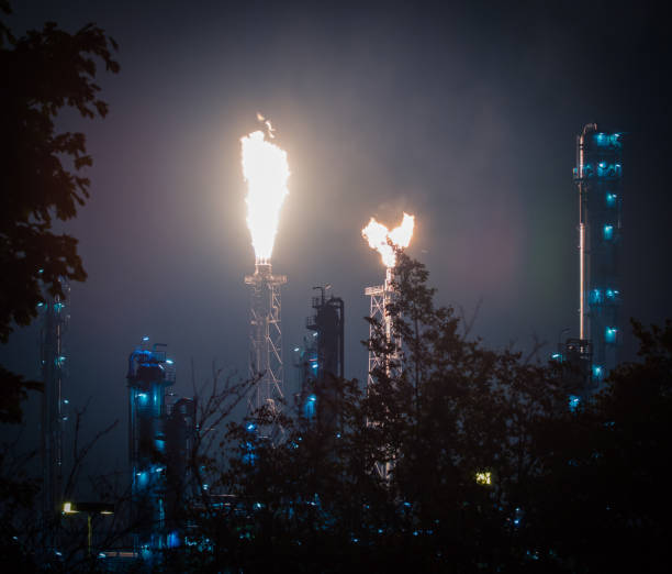 istock Fire towers in a refinery at night 1181061668