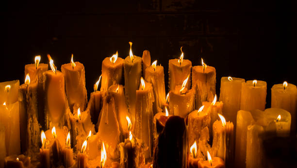 istock melted and burning candles on a natural brick wall background 1181061862