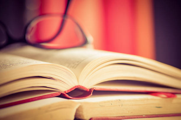 istock Glasses lies on red books 1181061879