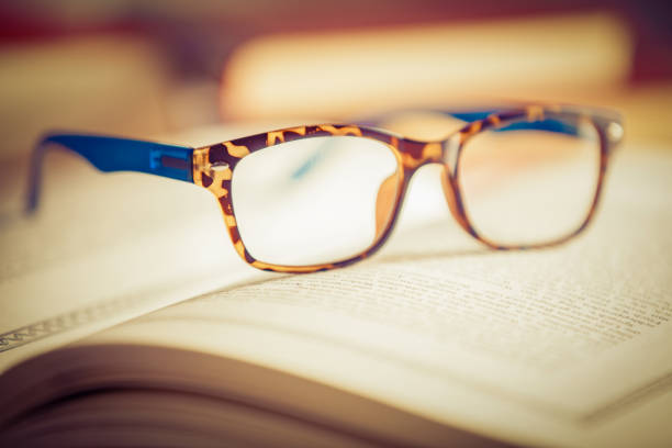 istock Glasses lies on red books 1181061932