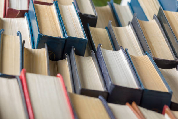 istock Open book, hardback books on wooden table. Back to school. Copy space 1181062040