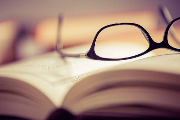 istock Glasses lies on red books 1181062680