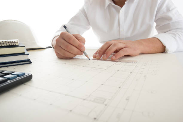 architects working on blueprint, real estate project. architect workplace - architectural project, blueprints, ruler, calculator, laptop and divider compass. construction concept. engineering tools. - housing project organization meeting real estate imagens e fotografias de stock