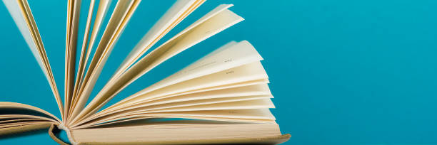 istock Open book, hardback books on wooden table. Back to school. Copy space 1181062946