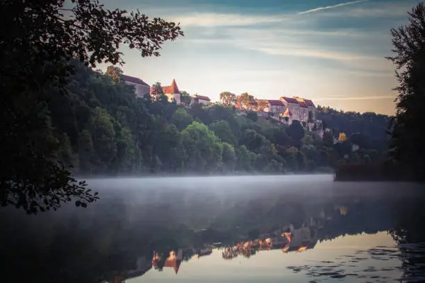 Misty morning at the wöhrsee in burghausen .With the castle in the background.