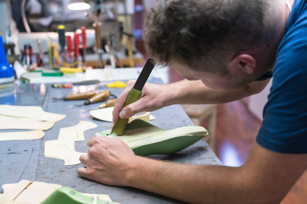 istock Shoemaker in shoe repair shop 1181063074