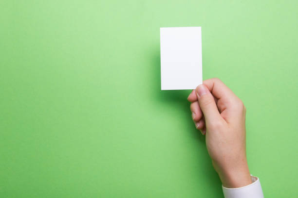 istock Hand holding white business card on white background 1181063090
