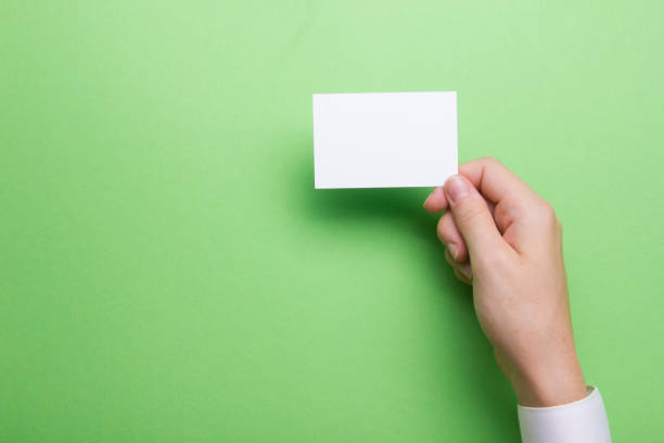 istock Hand holding white business card on white background 1181063194