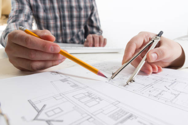 architects working on blueprint, real estate project. architect workplace - architectural project, blueprints, ruler, calculator, laptop and divider compass. construction concept. engineering tools. - housing project organization meeting real estate imagens e fotografias de stock