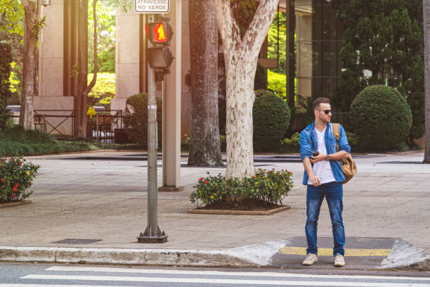 istock Young man waiting for taxi 1181063578