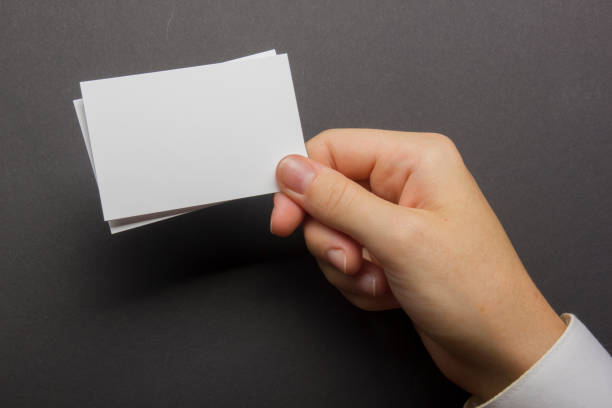 istock Hand holding white business card on white background 1181063635