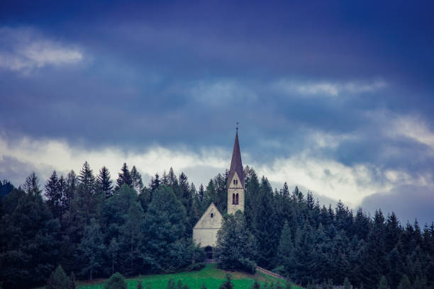 Little church st. magdalena near sterzing in the austrian alps on a cloudy day with dramatic sky