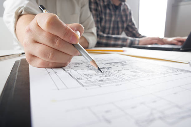 architects working on blueprint, real estate project. architect workplace - architectural project, blueprints, ruler, calculator, laptop and divider compass. construction concept. engineering tools. - housing project organization meeting real estate imagens e fotografias de stock