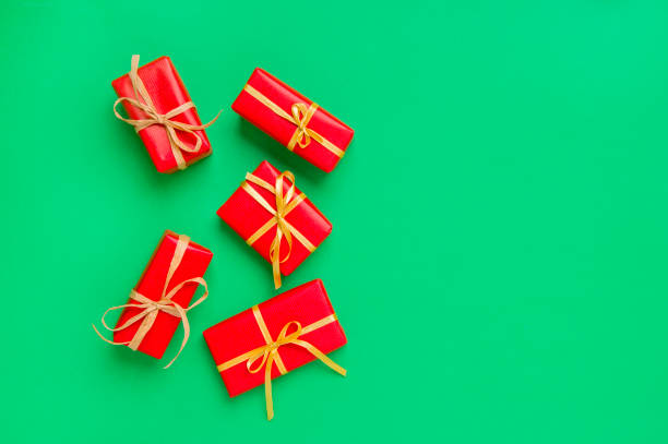 istock Christmas Gift Boxes Placed On Green Background 1181065090
