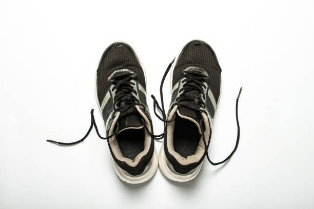istock Old, worn sneakers with holes on a white background. Concept of running, marathon, ultramarathon, long workout. Flat lay, top view 1181069708
