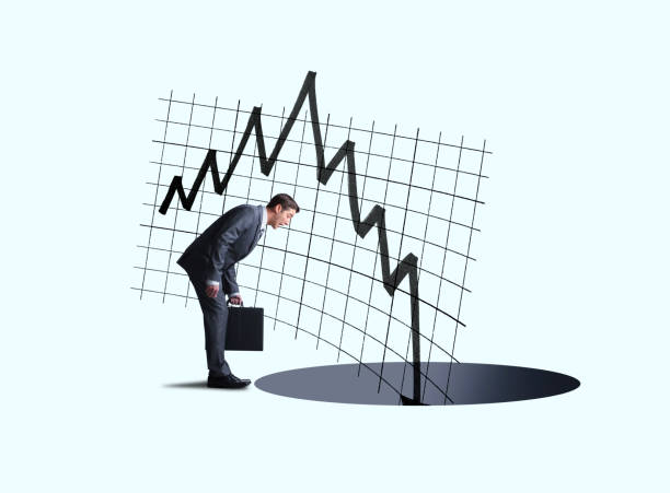 istock Businessman Watching Stock Prices Fall Into A Hole 1181076523