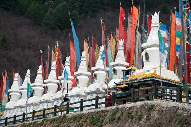 Tengboche, Nepal - May 23 2017-Twin deers symbolizing the skillful means and wisdom principles of Buddhist belief along with the Dhamma chakra on top of Tengboche Monastery in Nepal