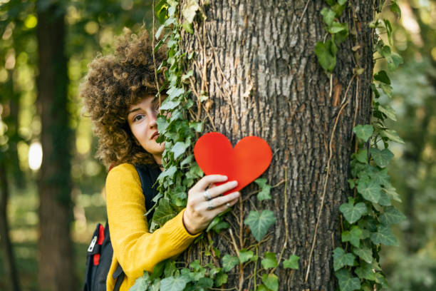 istock Closeup hands of woman hugging tree with heart shape, copy space. 1181077112
