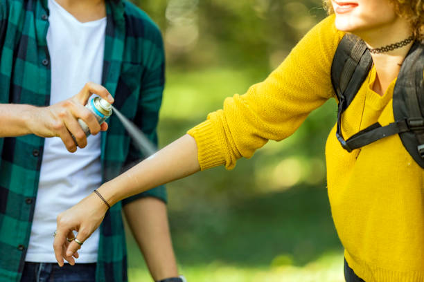 istock Using anti mosquito spray outdoors at hiking trip 1181077326