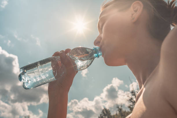 istock Woman drinking water 1181078396