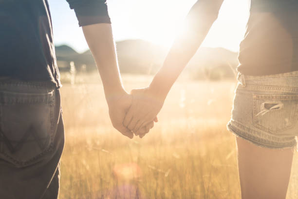 istock Couple holding hands at sunset 1181078417