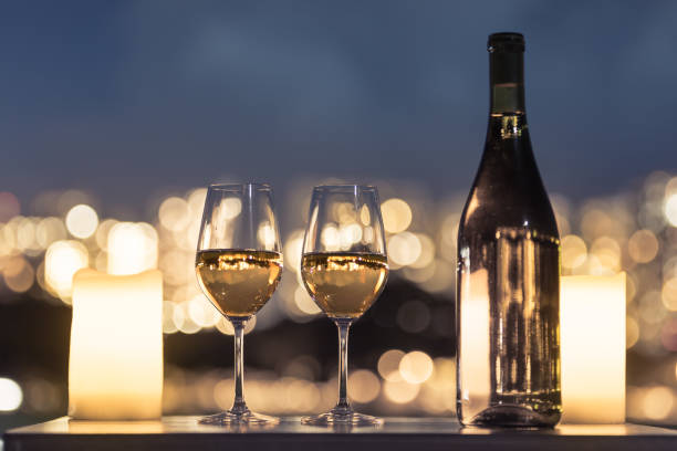 romantic setting in the night city - restaurant wine table table for two imagens e fotografias de stock