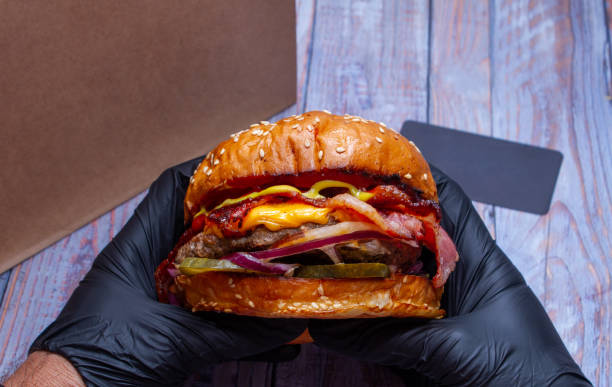 istock Juicy beef burger with bacon, cheese. Close-up. 1181081272