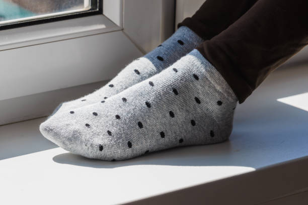 istock Woman wearing grey dotted socks 1181082605