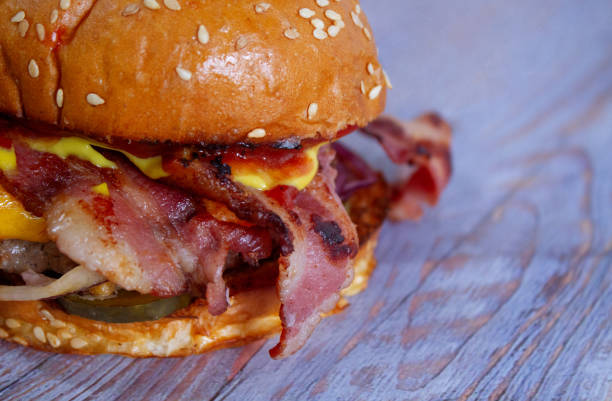 istock Juicy beef burger with bacon, cheese. Close-up. 1181083611